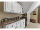 Wet bar area with white cabinetry, dark counters, a mini fridge and wine rack at 7620 Rainwater Rd, Raleigh, NC 27615