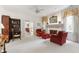 Cozy living room with comfortable seating, a fireplace, built in shelving, and neutral carpeting at 7620 Rainwater Rd, Raleigh, NC 27615