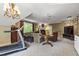 Spacious living room with exercise equipment, a comfortable seating area, and a fireplace at 7620 Rainwater Rd, Raleigh, NC 27615