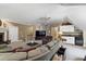 Large living room with fireplace, small kitchenette and a comfortable seating area with a large-screen TV at 7620 Rainwater Rd, Raleigh, NC 27615