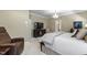 Spacious main bedroom featuring large windows, an accent chair, and neutral decor at 7620 Rainwater Rd, Raleigh, NC 27615