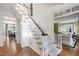 Elegant staircase with hardwood floors, and access to multiple rooms at 7620 Rainwater Rd, Raleigh, NC 27615