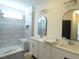 Elegant bathroom with dual vanities, walk-in shower, and sleek tile finishes at 776 Shadetree Rd, Benson, NC 27504