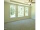 Comfortable bedroom with a ceiling fan and large windows overlooking the backyard at 776 Shadetree Rd, Benson, NC 27504
