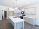 Modern kitchen with gray cabinets, quartz countertops, stainless steel appliances, and an island at 776 Shadetree Rd, Benson, NC 27504