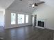 Spacious open-concept living room featuring a fireplace, large windows, and wood flooring at 776 Shadetree Rd, Benson, NC 27504