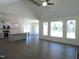 Bright, open-concept living room featuring large windows, vaulted ceilings, and wood flooring that connects to the kitchen at 776 Shadetree Rd, Benson, NC 27504