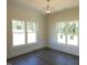 Bright living room with two large windows and modern chandelier lighting at 776 Shadetree Rd, Benson, NC 27504