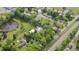 Property aerial view showcasing verdant trees, lawn, pond, and railroad tracks adjacent to the community at 7920 E Washington St, Mebane, NC 27302