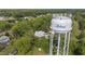 Water tower stands in front of the house with surrounding trees at 7920 E Washington St, Mebane, NC 27302