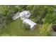 Aerial view featuring a bright backyard with an open patio and covered seating space for gatherings at 7920 E Washington St, Mebane, NC 27302