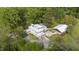 A sprawling property featuring a well-kept lawn, ample parking, and large, mature trees at 7920 E Washington St, Mebane, NC 27302