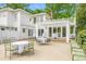 Charming white home featuring a spacious backyard patio, perfect for outdoor entertaining at 7920 E Washington St, Mebane, NC 27302