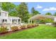 Picturesque backyard with lush lawn, patios and mature trees, offering a private oasis for relaxation and outdoor activities at 7920 E Washington St, Mebane, NC 27302