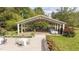 Picturesque outdoor event space with tables, chairs, chandelier, and lush landscaping at 7920 E Washington St, Mebane, NC 27302