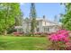 Sprawling home features a columned facade, balcony, and meticulously manicured landscaping at 7920 E Washington St, Mebane, NC 27302