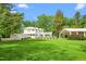 Beautiful white home complemented by a lush green lawn and spacious outdoor event pavilion at 7920 E Washington St, Mebane, NC 27302