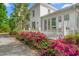 Charming white home with lush landscaping and a welcoming front porch at 7920 E Washington St, Mebane, NC 27302