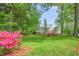 Home view, highlighting its lush greenery, well-maintained lawn, and stately facade at 7920 E Washington St, Mebane, NC 27302