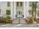 Elegant front entrance with grand pillars, a glass door, and meticulously manicured landscaping at 7920 E Washington St, Mebane, NC 27302