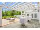 Expansive patio featuring bistro tables under a pergola, perfect for outdoor dining and enjoying scenic views of the property at 7920 E Washington St, Mebane, NC 27302