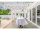 Inviting patio with bistro tables under a pergola, creates a relaxing outdoor retreat with a view of the beautifully maintained home at 7920 E Washington St, Mebane, NC 27302