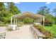 Scenic outdoor pavilion with tables, surrounded by lush greenery, creating an idyllic setting for events and gatherings at 7920 E Washington St, Mebane, NC 27302