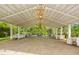 Spacious event pavilion adorned with chandeliers and surrounded by verdant scenery at 7920 E Washington St, Mebane, NC 27302