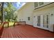 A wooden back deck with access to a well-maintained yard and the house's exterior at 8 Summertime Ct, Durham, NC 27707