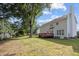 Spacious backyard featuring the back of the home, a wood deck, and mature trees at 8 Summertime Ct, Durham, NC 27707