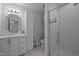 Bathroom featuring white vanity, shower with glass door and tiled walls at 8 Summertime Ct, Durham, NC 27707