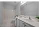 Bathroom featuring double vanity, a large mirror, and a shower tub combo at 8 Summertime Ct, Durham, NC 27707