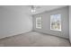 Bedroom featuring plush carpet, neutral walls, and natural light from the windows at 8 Summertime Ct, Durham, NC 27707