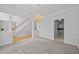 Elegant dining room with chandelier, staircase view, and neutral carpet at 8 Summertime Ct, Durham, NC 27707