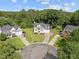 An exterior shot of a beautiful home with a well-manicured lawn in a quiet neighborhood at 8 Summertime Ct, Durham, NC 27707