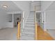 Spacious foyer with staircase, wood flooring, and views into the living areas at 8 Summertime Ct, Durham, NC 27707