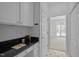 Home office with granite countertops, custom cabinets, and a view to the home's entrance at 8 Summertime Ct, Durham, NC 27707