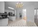 Well-lit kitchen with white cabinets, black countertops, stainless appliances, and center island at 8 Summertime Ct, Durham, NC 27707