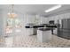 Bright kitchen features stainless appliances, white cabinets, granite countertops, and center island at 8 Summertime Ct, Durham, NC 27707