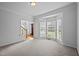 Bright living room with bay window offering lots of natural light and stairs with hardwood floors at 8 Summertime Ct, Durham, NC 27707