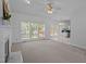 Inviting living room featuring neutral carpet, large windows, fireplace and ceiling fan at 8 Summertime Ct, Durham, NC 27707