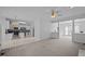 Spacious open concept with kitchen and living areas with a ceiling fan and neutral colors at 8 Summertime Ct, Durham, NC 27707