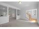 Spacious living room with white columns, neutral carpet, and views to additional living spaces at 8 Summertime Ct, Durham, NC 27707
