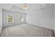 Spacious main bedroom featuring plush carpet, crown molding, and a ceiling fan at 8 Summertime Ct, Durham, NC 27707