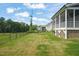 Spacious and well-maintained backyard with lush green grass, privacy fence, and screened porch with a beautiful view at 815 Laurelwood Dr, Durham, NC 27705