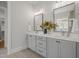 Bathroom featuring double sinks, framed mirrors and a neutral color palette at 815 Laurelwood Dr, Durham, NC 27705