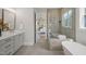 Bathroom featuring a glass shower, soaking tub, neutral color palette and stylish fixtures at 815 Laurelwood Dr, Durham, NC 27705