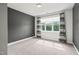 Carpeted bedroom featuring a large window with curtains and a dark painted accent wall at 815 Laurelwood Dr, Durham, NC 27705