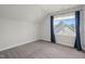 Carpeted room featuring an attic style roof, window with dark blue curtains at 815 Laurelwood Dr, Durham, NC 27705
