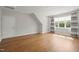Bedroom with wood floors, a window with curtains and a closet door at 815 Laurelwood Dr, Durham, NC 27705